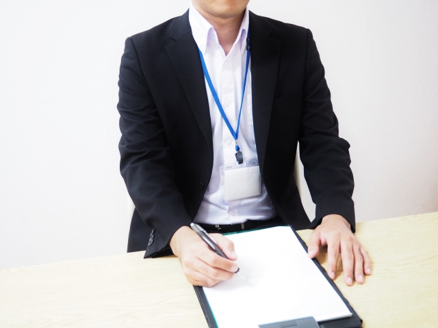 机で相談にのるスーツ姿の担当者